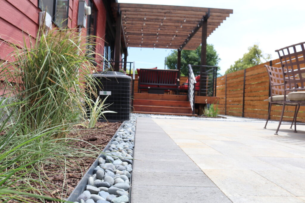 Modern patio with pergola and garden pathway.