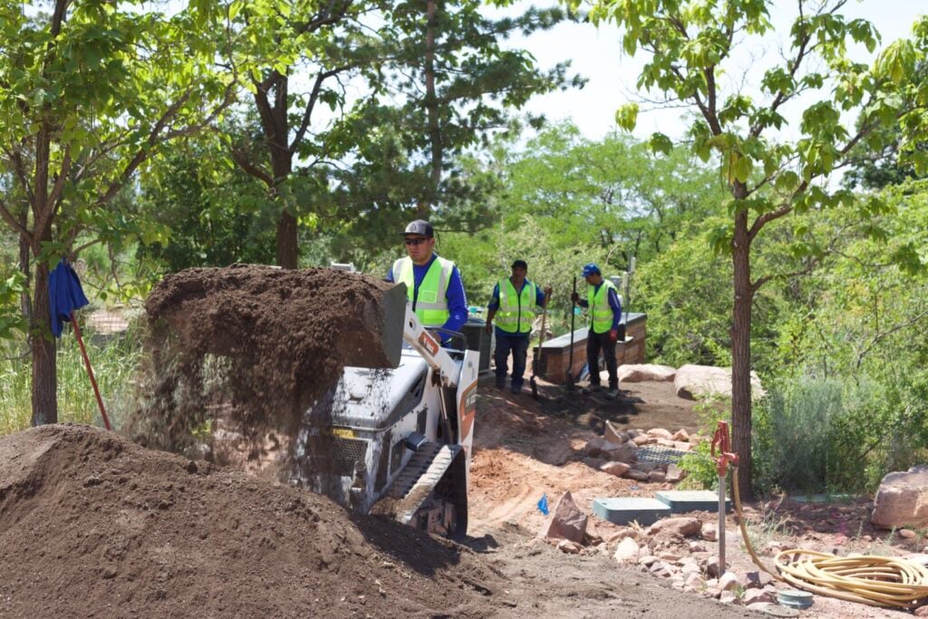 Skid steer moving mount of dirt