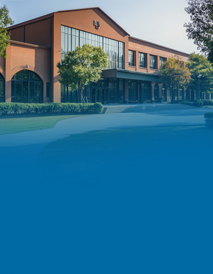Modern brick building with large windows at sunset.