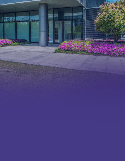 Modern building with glass facade and flowers