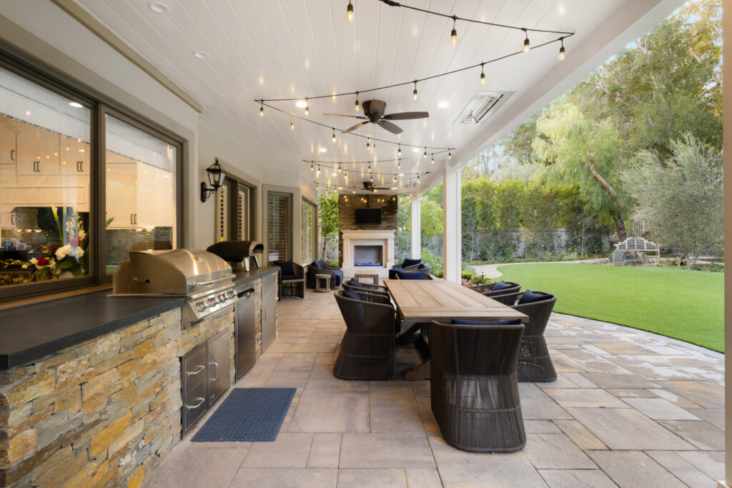 Modern patio with dining area and outdoor kitchen.