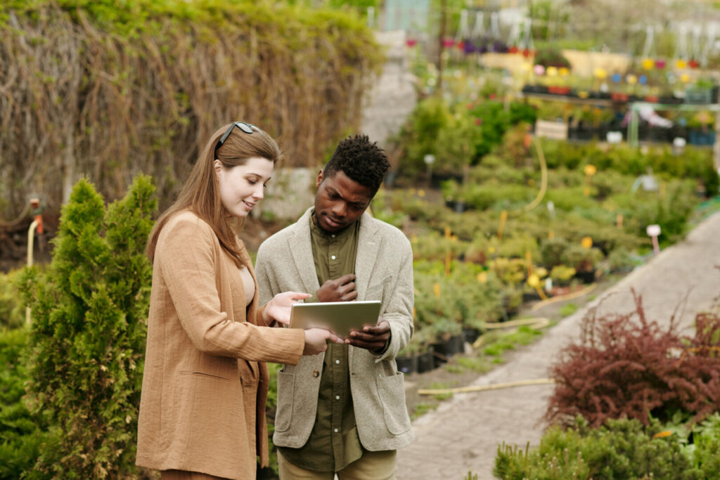 People discussing plants in a garden center.
